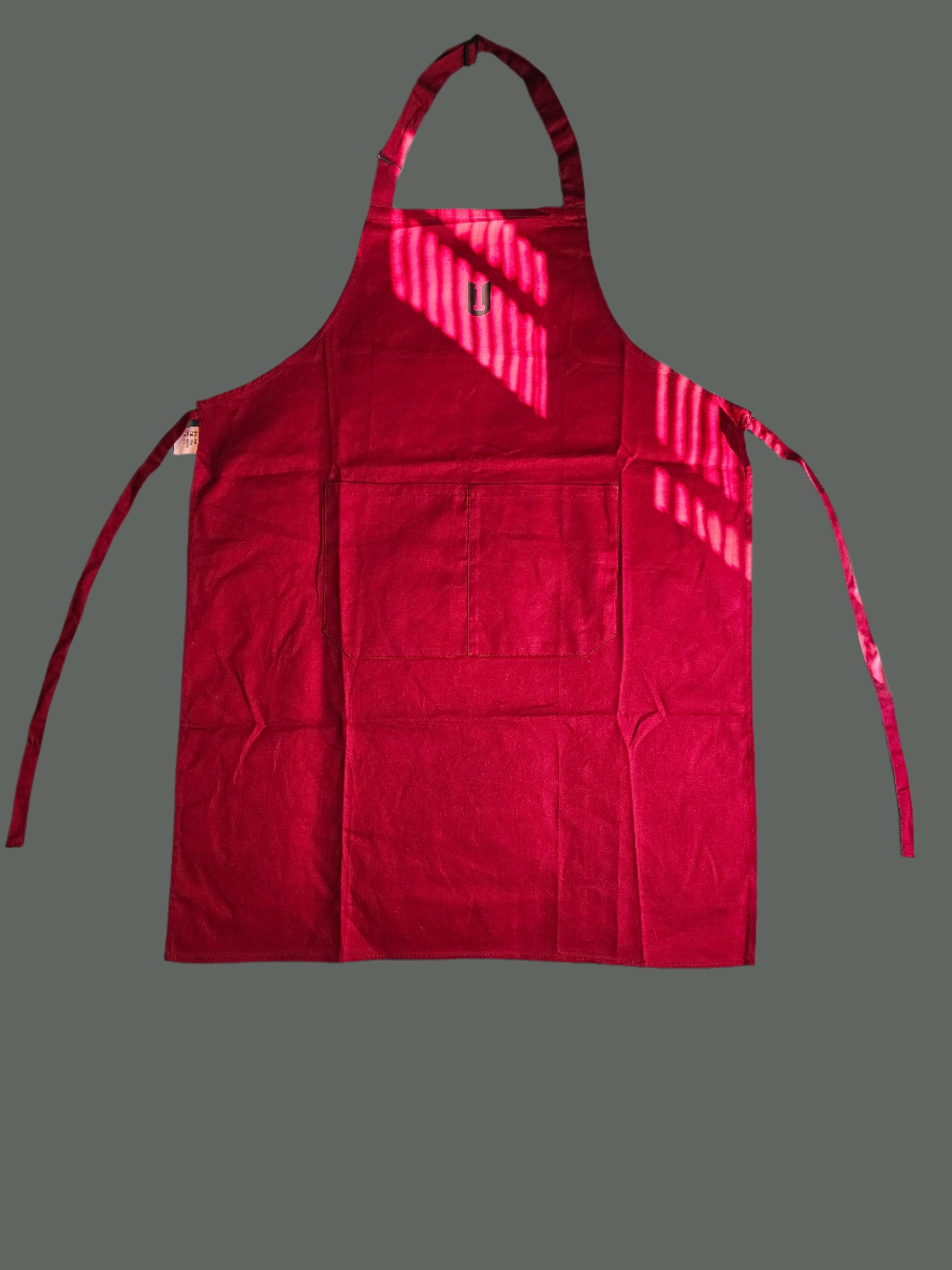 Utility Apron. A Sturdy cotton material.  adjustable neck strap, and  straps for tying .Fun to wear.